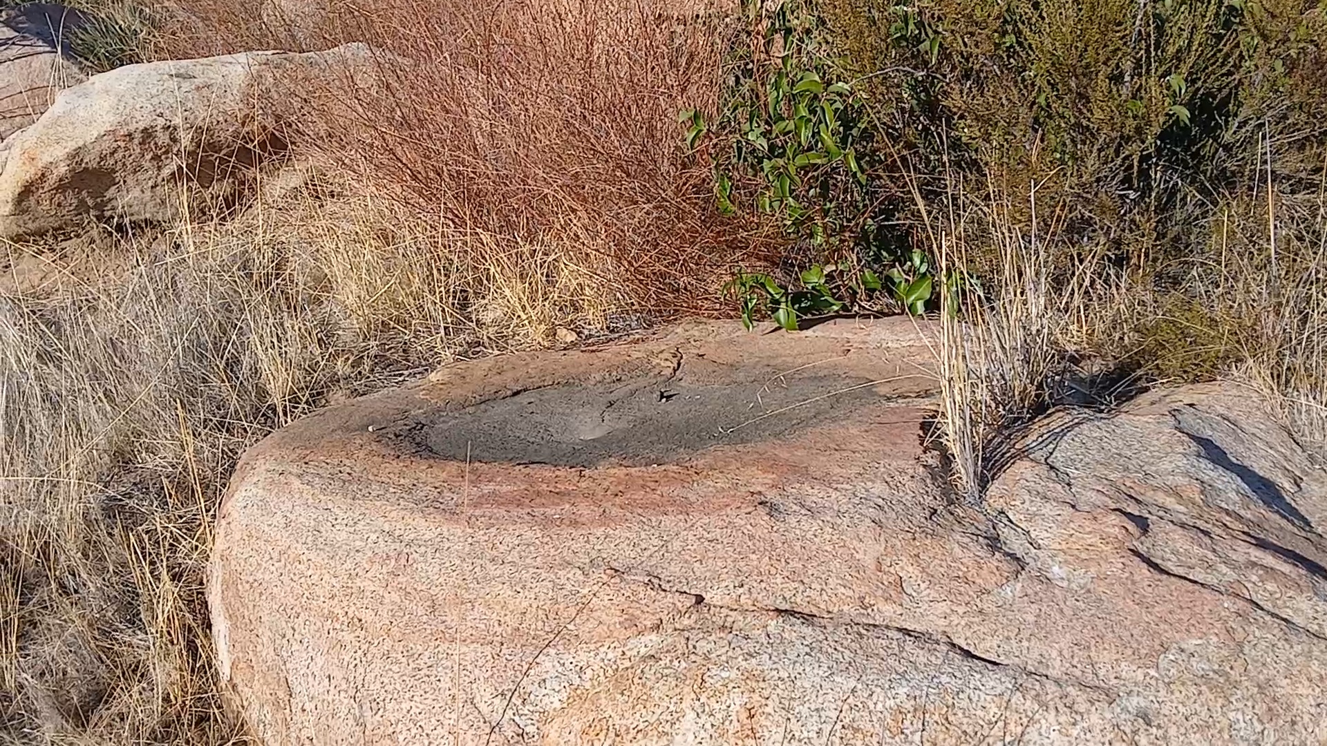 Fire-darkened boulder depressions